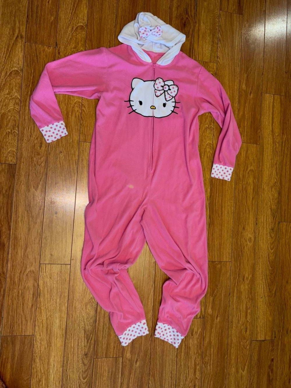 Pink Hello Kitty onesie with white polka dots and bow